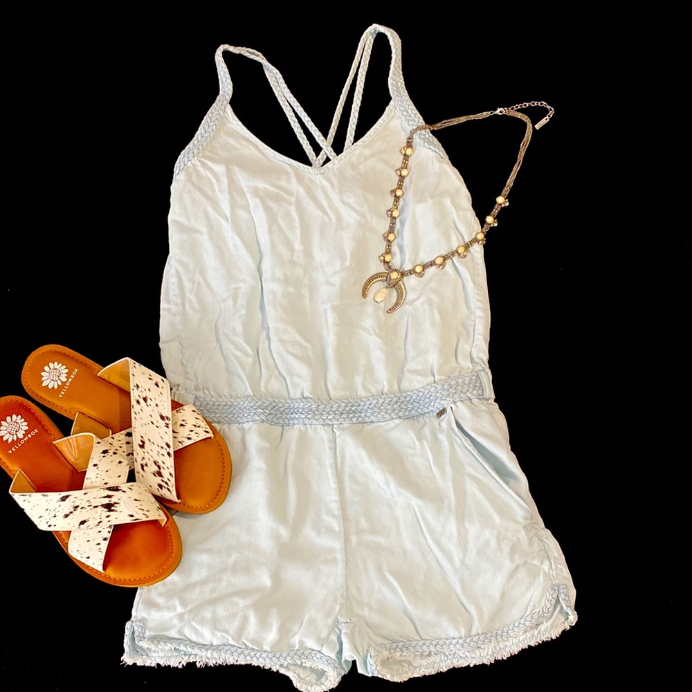 Small Light Blue Denim Romper with Criss Cross Back and Woven accents.